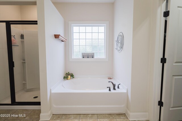 411 Canvasback Ln, Sneads Ferry, NC 28460 - full bath with a garden tub, a stall shower, and baseboards