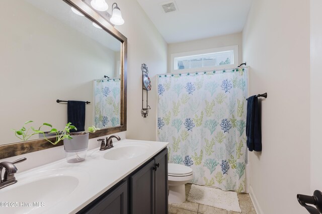 411 Canvasback Ln, Sneads Ferry, NC 28460 - full bathroom featuring toilet, double vanity, and curtained shower