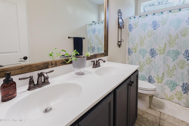 411 Canvasback Ln, Sneads Ferry, NC 28460 - full bathroom with toilet, double vanity, curtained shower, and tile patterned floors