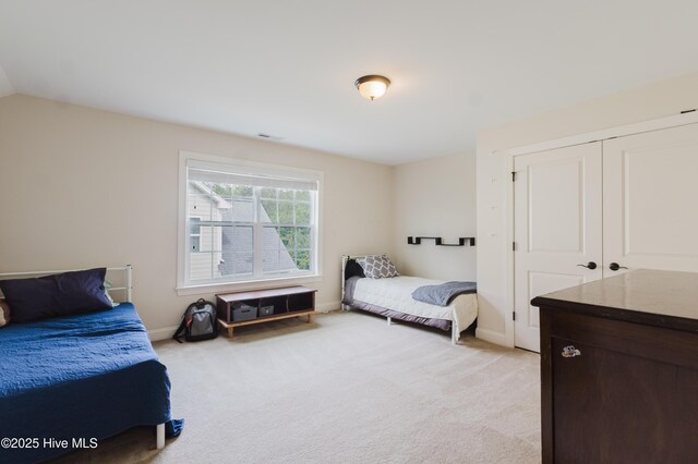 411 Canvasback Ln, Sneads Ferry, NC 28460 - bedroom featuring light colored carpet, a closet, baseboards, and vaulted ceiling