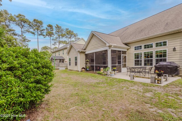 411 Canvasback Ln, Sneads Ferry, NC 28460 - rear view of property with a sunroom, a patio, and a lawn