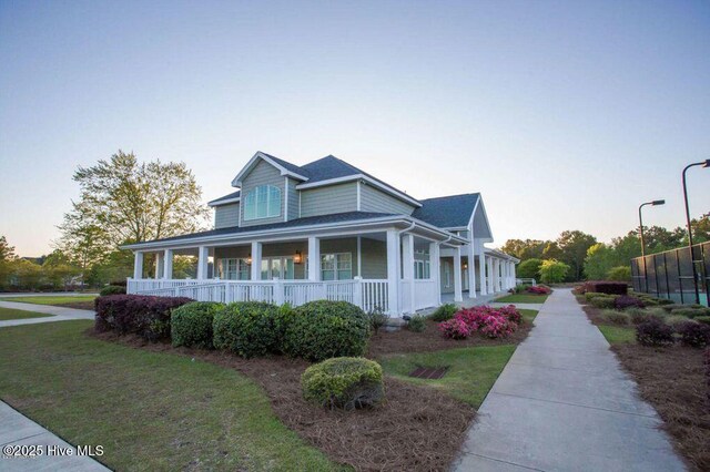 411 Canvasback Ln, Sneads Ferry, NC 28460 - view of front of property with a porch and a lawn