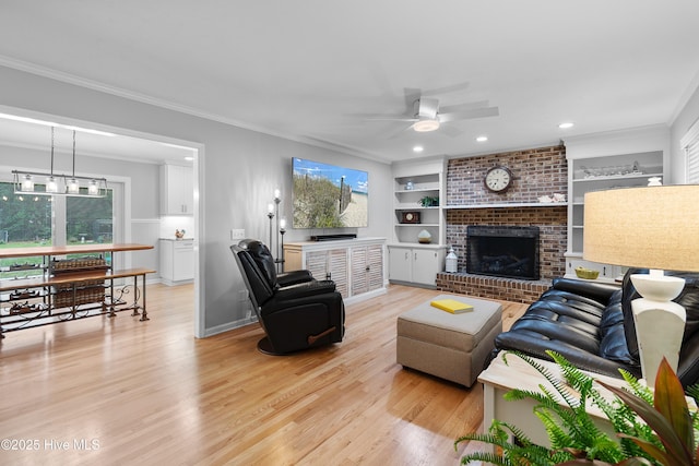 827 Village Point Rd SW, Shallotte, NC 28470 - living area with ceiling fan, light wood-style flooring, a brick fireplace, plenty of natural light, and ornamental molding