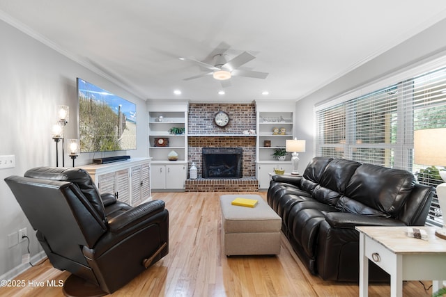 827 Village Point Rd SW, Shallotte, NC 28470 - living area with ornamental molding, ceiling fan, light wood-style floors, a brick fireplace, and built in shelves