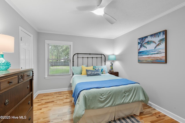 827 Village Point Rd SW, Shallotte, NC 28470 - bedroom with light wood finished floors, ornamental molding, baseboards, and ceiling fan