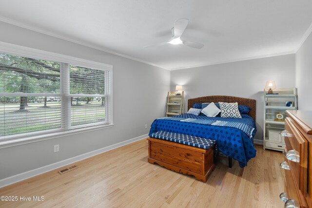 827 Village Point Rd SW, Shallotte, NC 28470 - bedroom with crown molding, light wood-type flooring, baseboards, and ceiling fan