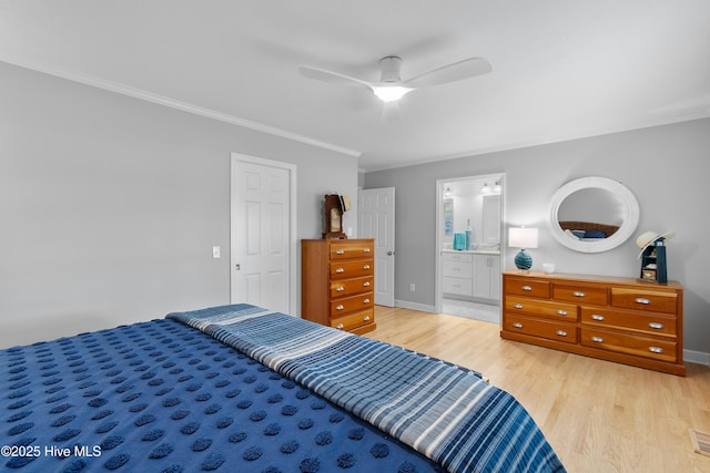 827 Village Point Rd SW, Shallotte, NC 28470 - bedroom with ornamental molding, light wood finished floors, baseboards, a ceiling fan, and ensuite bathroom