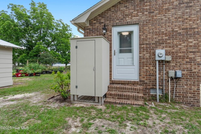 827 Village Point Rd SW, Shallotte, NC 28470 - doorway to property with brick siding and a lawn