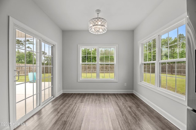 1005 Flounder Run, New Bern, NC 28562 - unfurnished dining area with plenty of natural light, a chandelier, and wood finished floors
