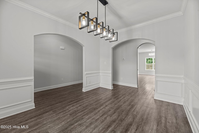 1005 Flounder Run, New Bern, NC 28562 - spare room featuring arched walkways, ornamental molding, dark wood finished floors, a wainscoted wall, and a decorative wall