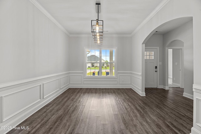 1005 Flounder Run, New Bern, NC 28562 - unfurnished dining area with arched walkways, dark wood-type flooring, crown molding, wainscoting, and a decorative wall