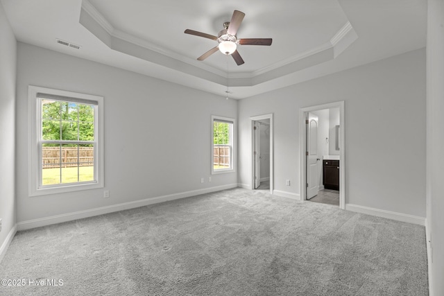 1005 Flounder Run, New Bern, NC 28562 - unfurnished bedroom with ornamental molding, a tray ceiling, carpet, baseboards, and a spacious closet