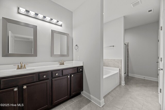 1005 Flounder Run, New Bern, NC 28562 - full bath featuring baseboards, double vanity, a bath, a stall shower, and tile patterned floors
