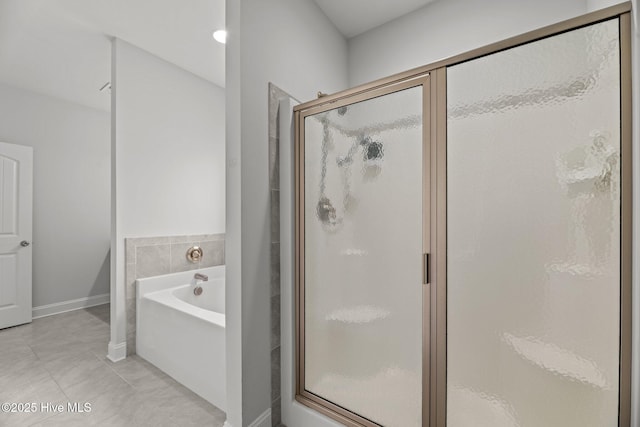 1005 Flounder Run, New Bern, NC 28562 - bathroom with a shower stall, a garden tub, baseboards, and tile patterned flooring
