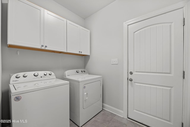 1005 Flounder Run, New Bern, NC 28562 - laundry room with cabinet space, washing machine and dryer, baseboards, and light tile patterned floors