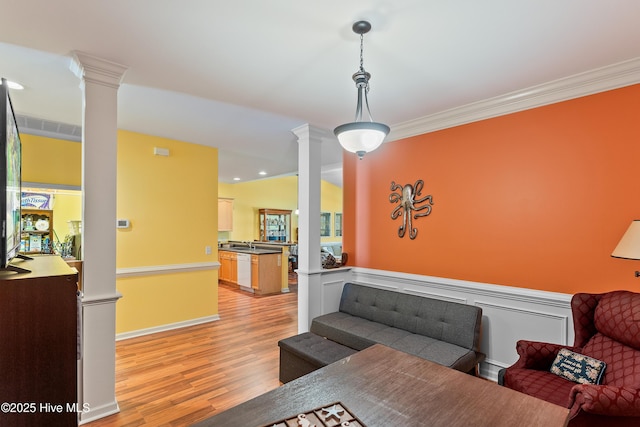 4256 Anderson Dr SE, Southport, NC 28461 - living area featuring ornate columns, light wood-type flooring, ornamental molding, and recessed lighting