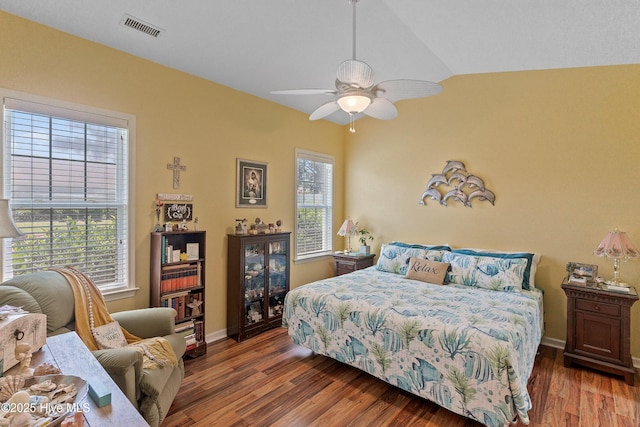 4256 Anderson Dr SE, Southport, NC 28461 - bedroom with multiple windows, wood finished floors, vaulted ceiling, baseboards, and ceiling fan