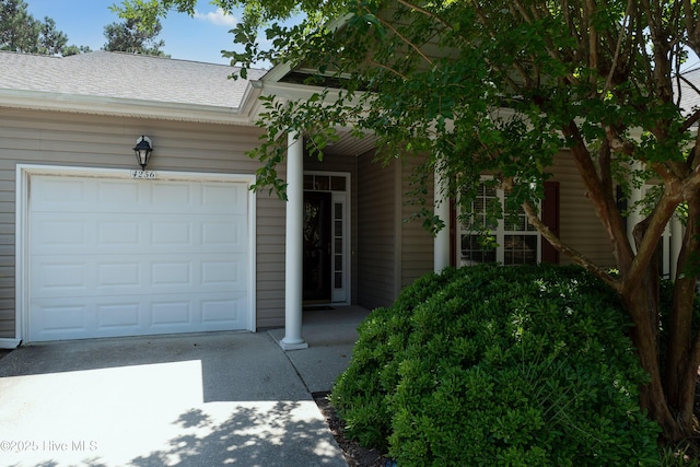 4256 Anderson Dr SE, Southport, NC 28461 - view of front facade with driveway, roof with shingles, and an attached garage