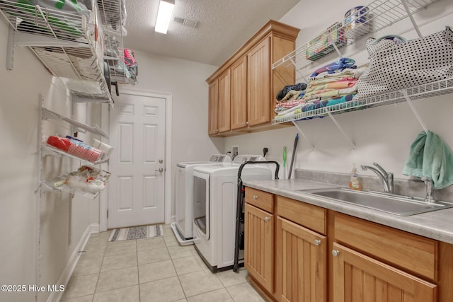 9116 Oak Ridge Plantation Dr, Calabash, NC 28467 - washroom with washer and clothes dryer, cabinet space, light tile patterned floors, and a textured ceiling
