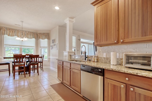 9116 Oak Ridge Plantation Dr, Calabash, NC 28467 - kitchen featuring dishwasher, light tile patterned floors, decorative backsplash, light stone counters, and a chandelier