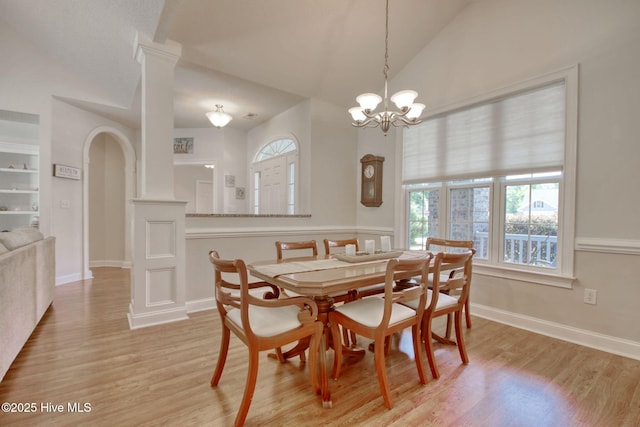 9116 Oak Ridge Plantation Dr, Calabash, NC 28467 - dining room with vaulted ceiling, ornate columns, light wood-style floors, a chandelier, and arched walkways