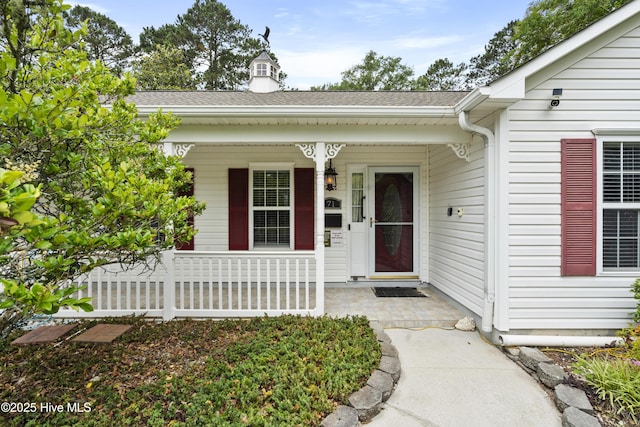 71 Combine Ln SE, Leland, NC 28451 - view of exterior entry with covered porch and roof with shingles
