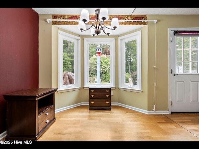 71 Combine Ln SE, Leland, NC 28451 - dining room with light wood finished floors, a chandelier, healthy amount of natural light, and baseboards