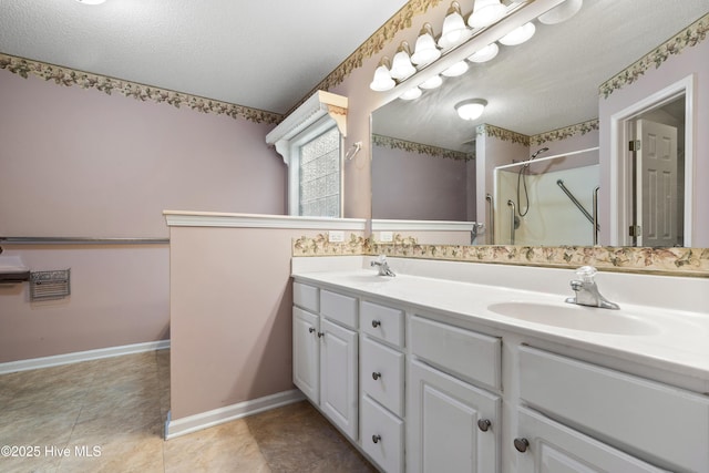 71 Combine Ln SE, Leland, NC 28451 - bathroom featuring double vanity, a stall shower, a textured ceiling, and baseboards