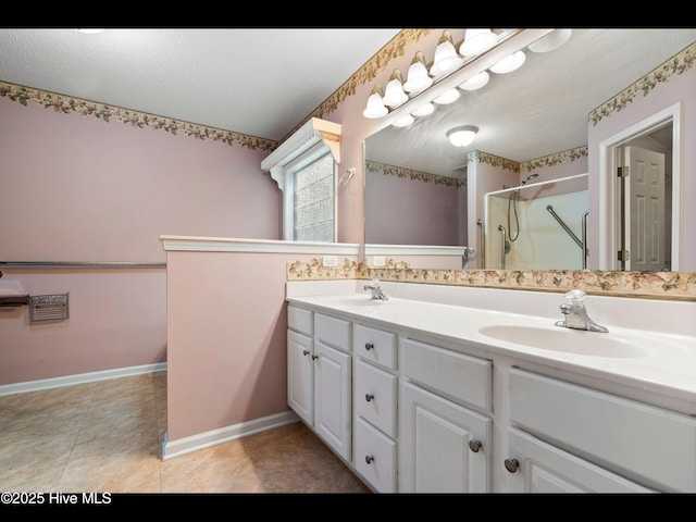 71 Combine Ln SE, Leland, NC 28451 - bathroom with double vanity, a shower stall, baseboards, and tile patterned flooring