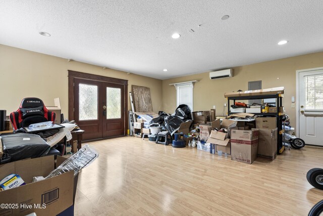 71 Combine Ln SE, Leland, NC 28451 - miscellaneous room featuring a textured ceiling, wood finished floors, recessed lighting, an AC wall unit, and french doors