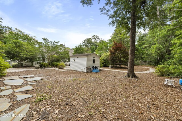 71 Combine Ln SE, Leland, NC 28451 - view of yard featuring view of wooded area and an outbuilding