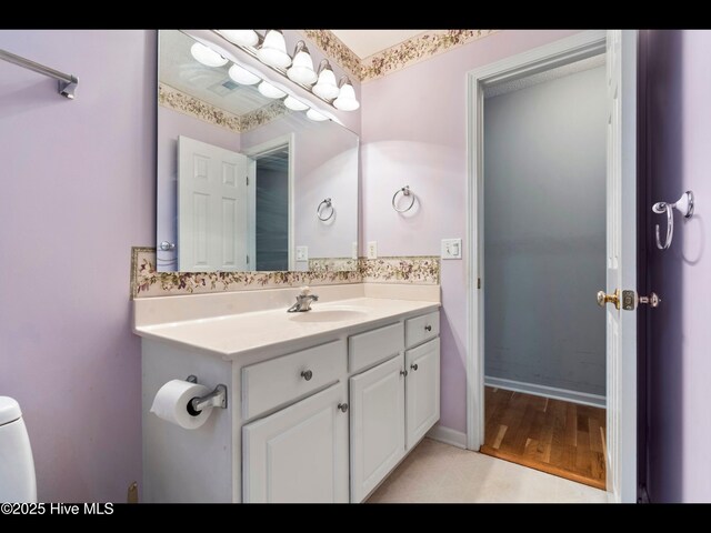 71 Combine Ln SE, Leland, NC 28451 - bathroom with vanity, toilet, and wood finished floors