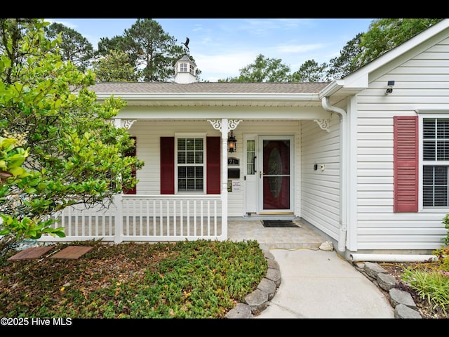 71 Combine Ln SE, Leland, NC 28451 - entrance to property featuring covered porch and a shingled roof