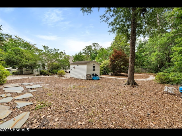 71 Combine Ln SE, Leland, NC 28451 - view of yard featuring an outbuilding and view of wooded area