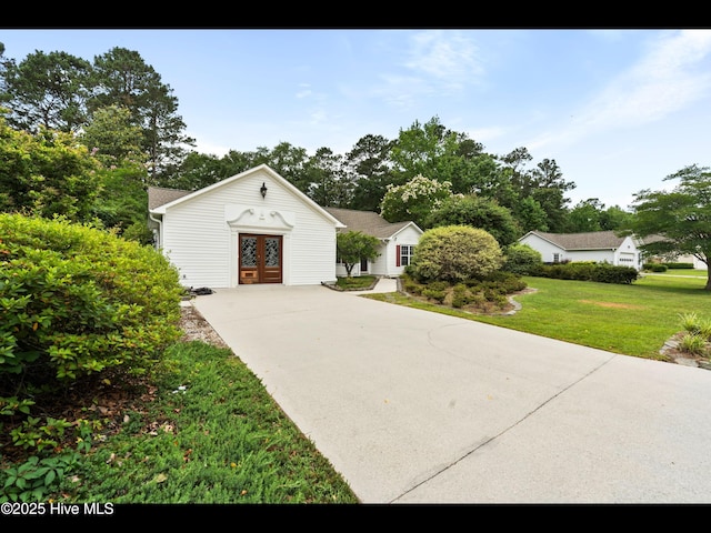 71 Combine Ln SE, Leland, NC 28451 - view of front facade with french doors, driveway, and a front lawn