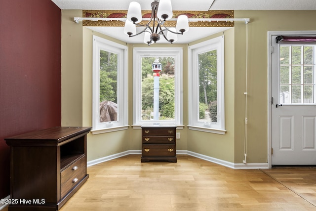 71 Combine Ln SE, Leland, NC 28451 - dining room featuring light wood finished floors, a chandelier, healthy amount of natural light, and baseboards