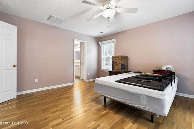 71 Combine Ln SE, Leland, NC 28451 - bedroom featuring wood finished floors, baseboards, connected bathroom, and a ceiling fan
