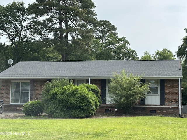 2611 Lisa Ln, Goldsboro, NC 27534 - view of front of property with brick siding, a front yard, and a shingled roof