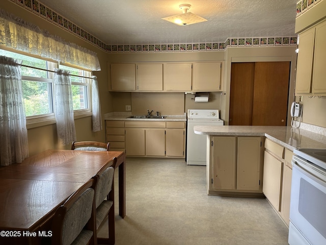 2611 Lisa Ln, Goldsboro, NC 27534 - kitchen with white electric range, a sink, light countertops, a peninsula, and cream cabinets