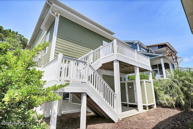 421 30th St, Sunset Beach, NC 28468 - view of home's exterior with a wooden deck and stairway