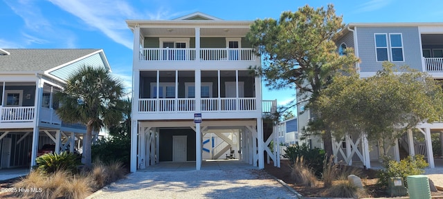 421 30th St, Sunset Beach, NC 28468 - coastal home featuring a carport, a balcony, and driveway