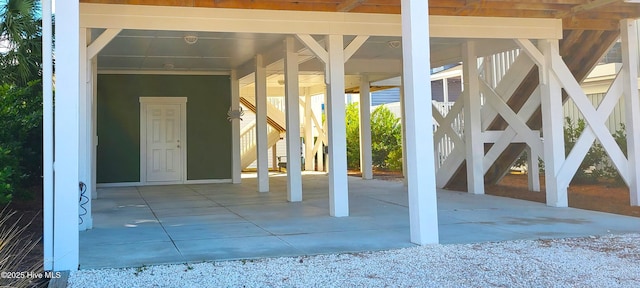 421 30th St, Sunset Beach, NC 28468 - view of exterior entry featuring a carport and driveway