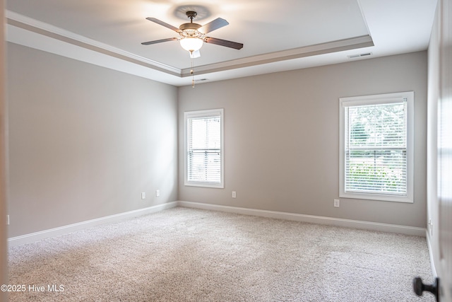255 Champions Ridge Dr, Southern Pines, NC 28387 - spare room featuring a raised ceiling, ceiling fan, carpet floors, and baseboards