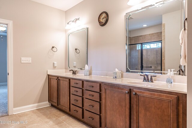 255 Champions Ridge Dr, Southern Pines, NC 28387 - bathroom featuring double vanity, a tile shower, baseboards, and tile patterned flooring