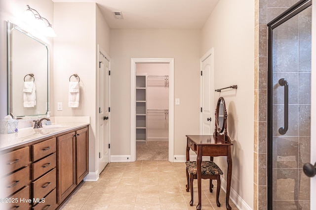 255 Champions Ridge Dr, Southern Pines, NC 28387 - bathroom with a stall shower, vanity, a spacious closet, and baseboards