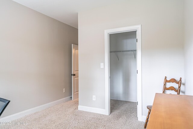 255 Champions Ridge Dr, Southern Pines, NC 28387 - bedroom with a walk in closet, baseboards, carpet flooring, and a closet