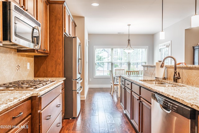 255 Champions Ridge Dr, Southern Pines, NC 28387 - kitchen with stainless steel appliances, a sink, healthy amount of natural light, brown cabinets, and recessed lighting