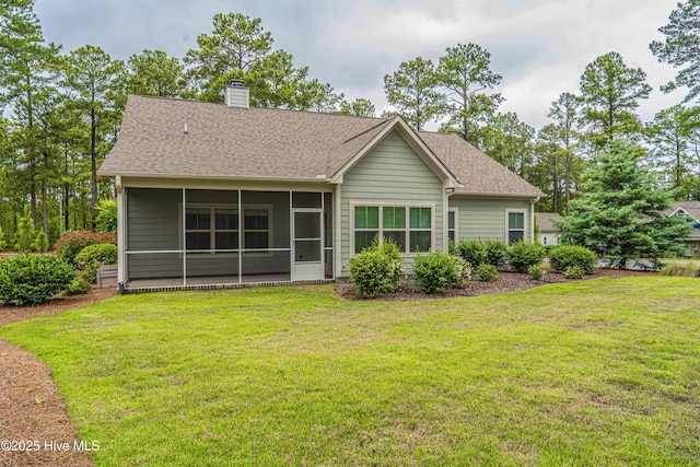 255 Champions Ridge Dr, Southern Pines, NC 28387 - view of front of house with a chimney, a sunroom, a front yard, and a shingled roof