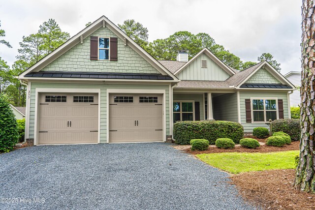 255 Champions Ridge Dr, Southern Pines, NC 28387 - craftsman inspired home featuring a standing seam roof, board and batten siding, a chimney, gravel driveway, and metal roof