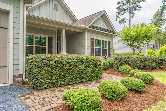 255 Champions Ridge Dr, Southern Pines, NC 28387 - view of front of property with board and batten siding and a shingled roof